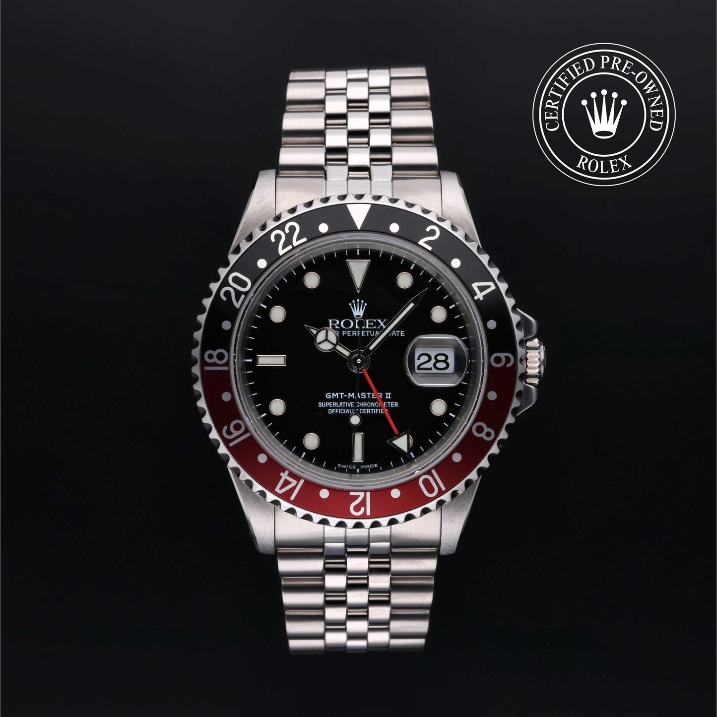Rolex GMT-Master II with Jubilee bracelet, red and black bezel and black dial on a black background.
