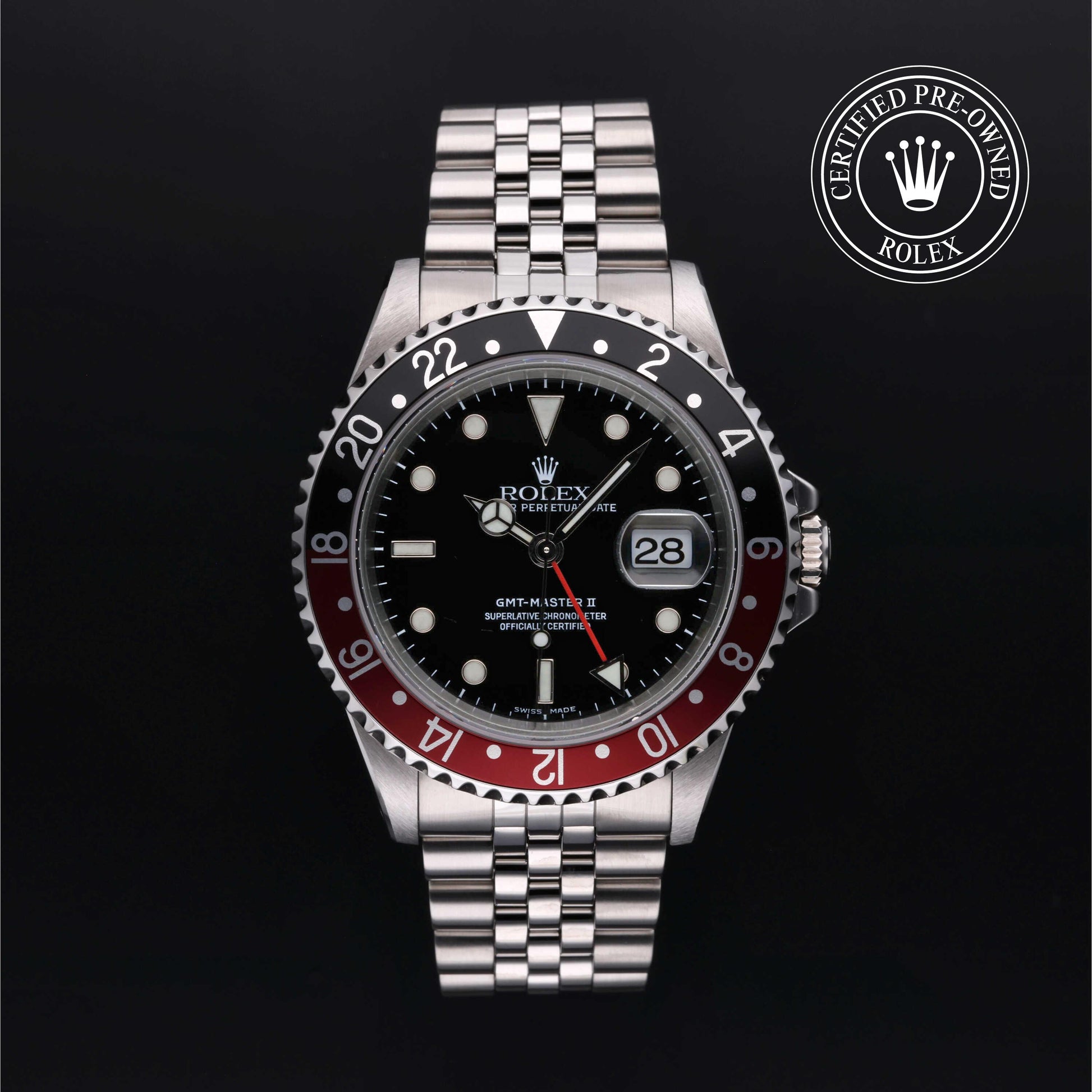 Rolex GMT-Master II with Jubilee bracelet, red and black bezel and black dial on a black background.