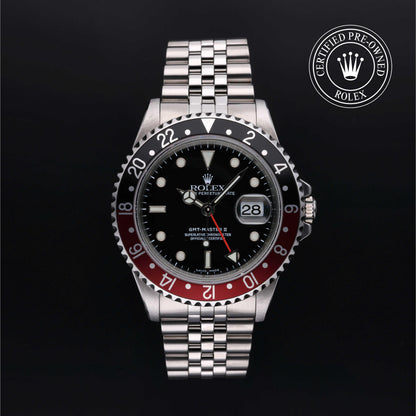 Rolex GMT-Master II with Jubilee bracelet, red and black bezel and black dial on a black background.