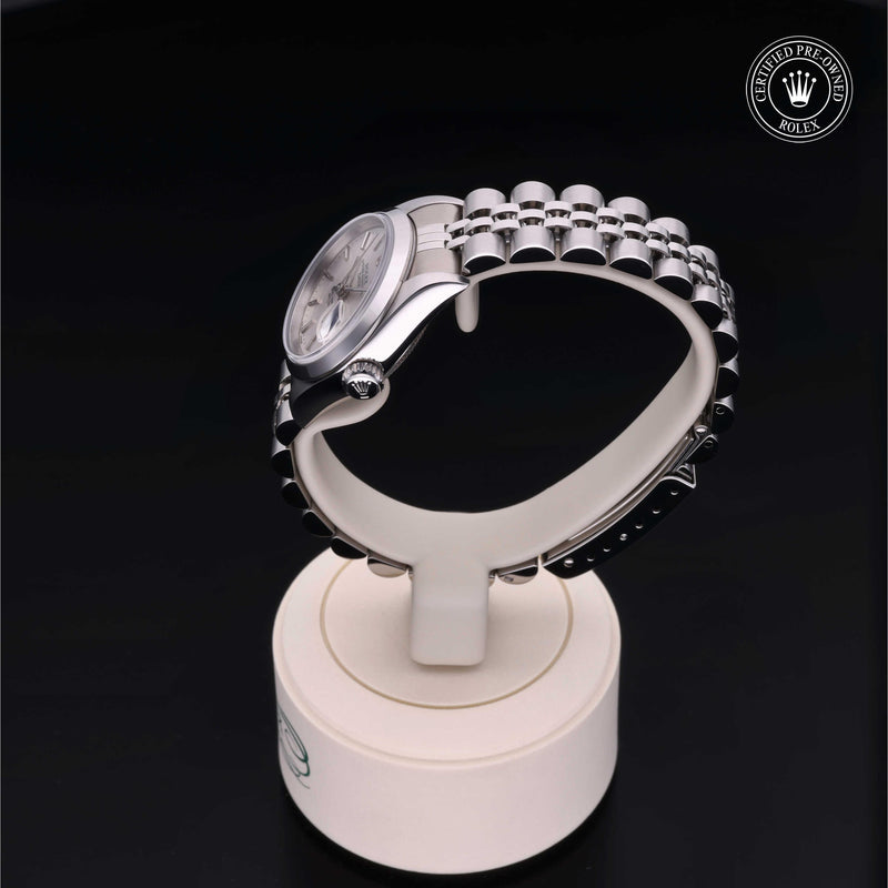 Rolex Lady-Datejust with steel Jubilee bracelet and silver dial on a presentation stand against a black background.Lady-Datejust 26