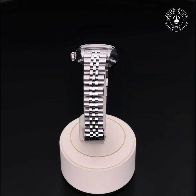 Rolex Lady-Datejust with steel Jubilee bracelet and silver dial on a presentation stand against a black background.Lady-Datejust 26