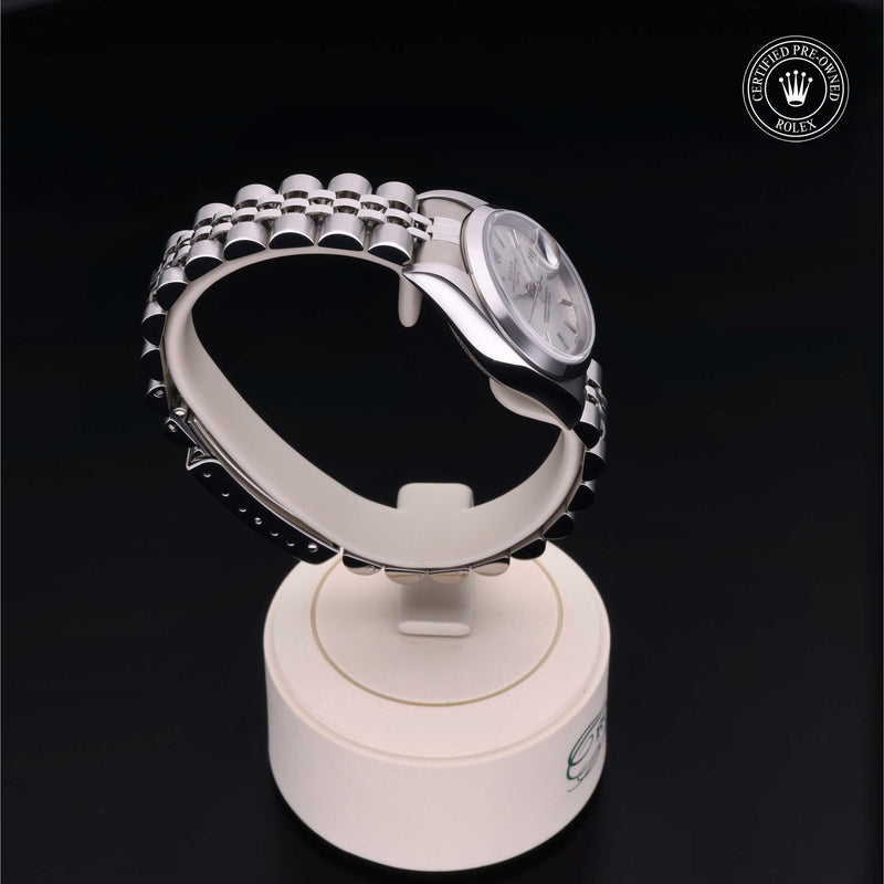 Rolex Lady-Datejust with steel Jubilee bracelet and silver dial on a presentation stand against a black background.Lady-Datejust 26