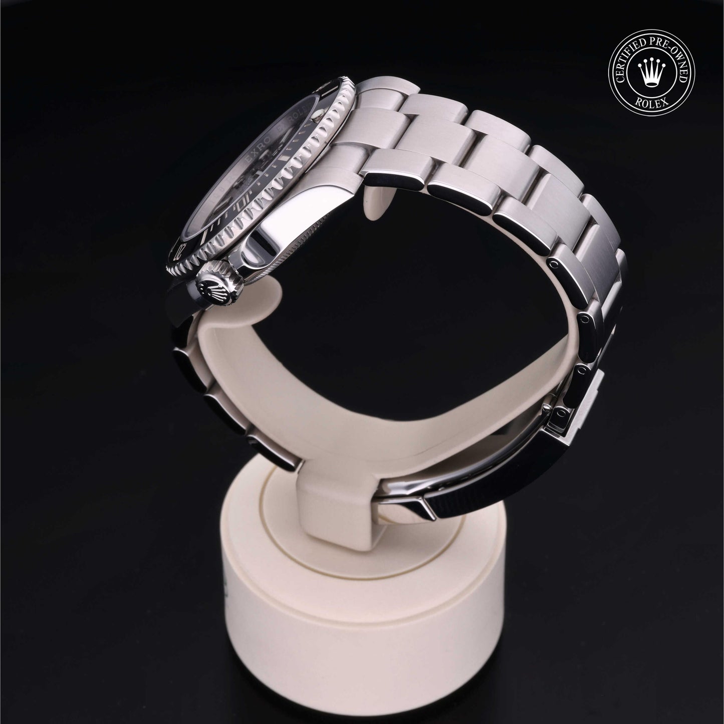 Rolex Submariner watch with steel Oyster bracelet and black dial on a white background.