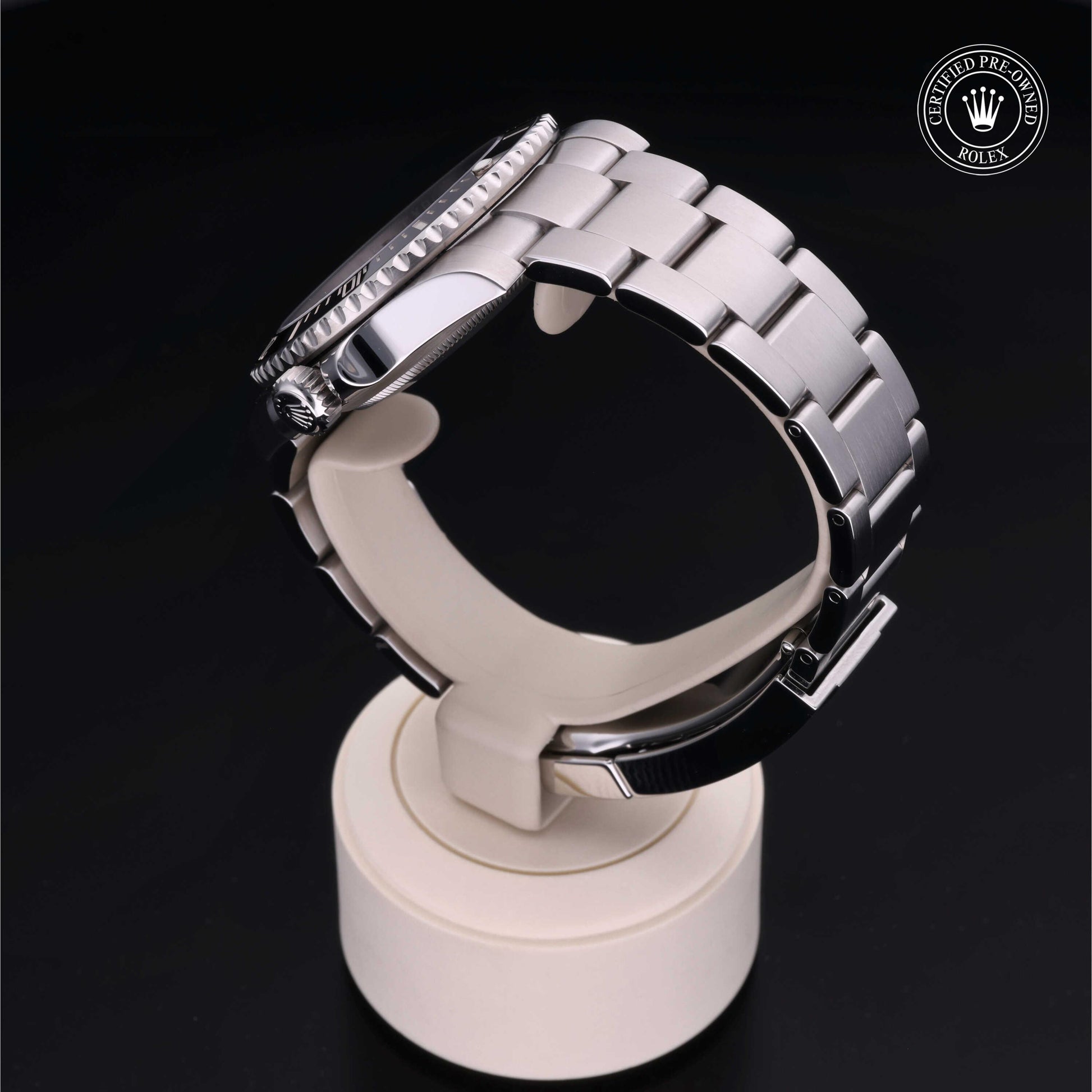 Rolex Submariner watch with steel Oyster bracelet and black dial on a white background.