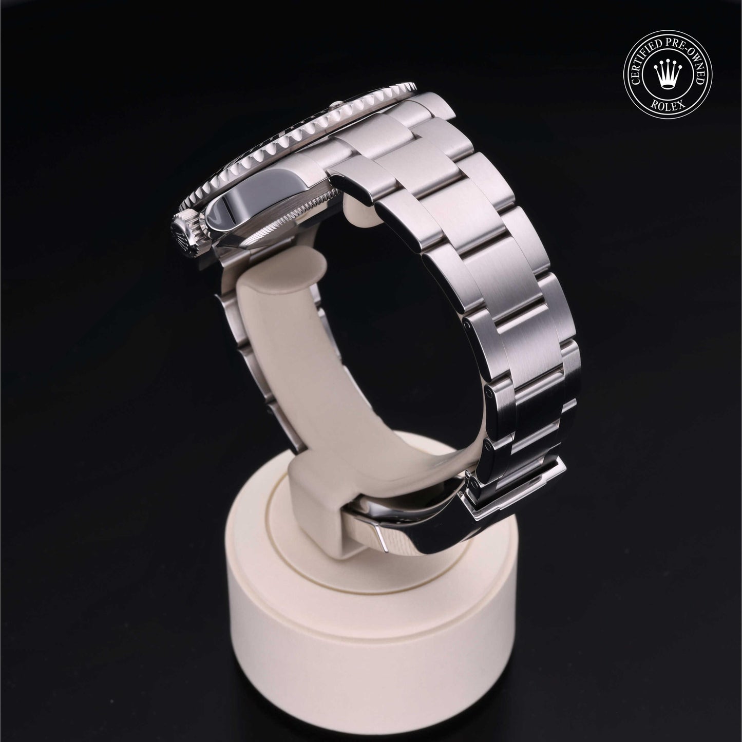 Rolex Submariner watch with steel Oyster bracelet and black dial on a white background.