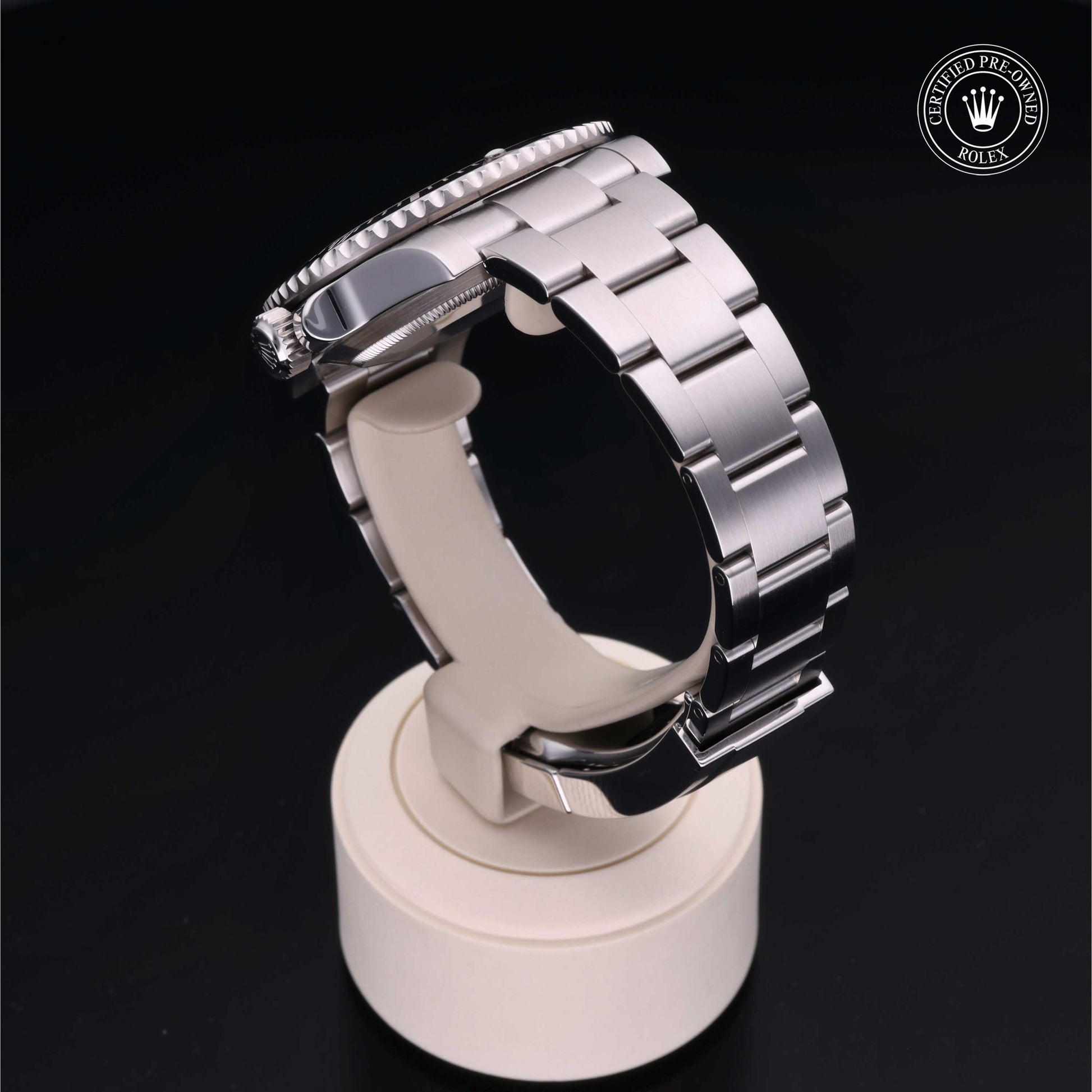 Rolex Submariner watch with steel Oyster bracelet and black dial on a white background.