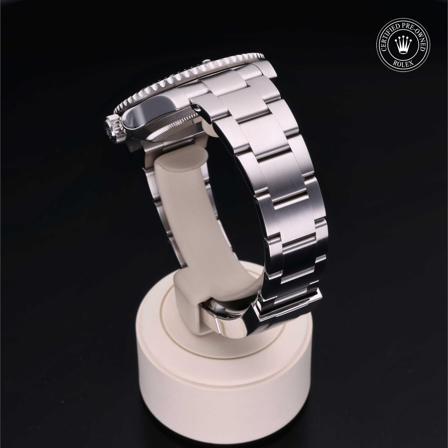 Rolex Submariner watch with steel Oyster bracelet and black dial on a white background.