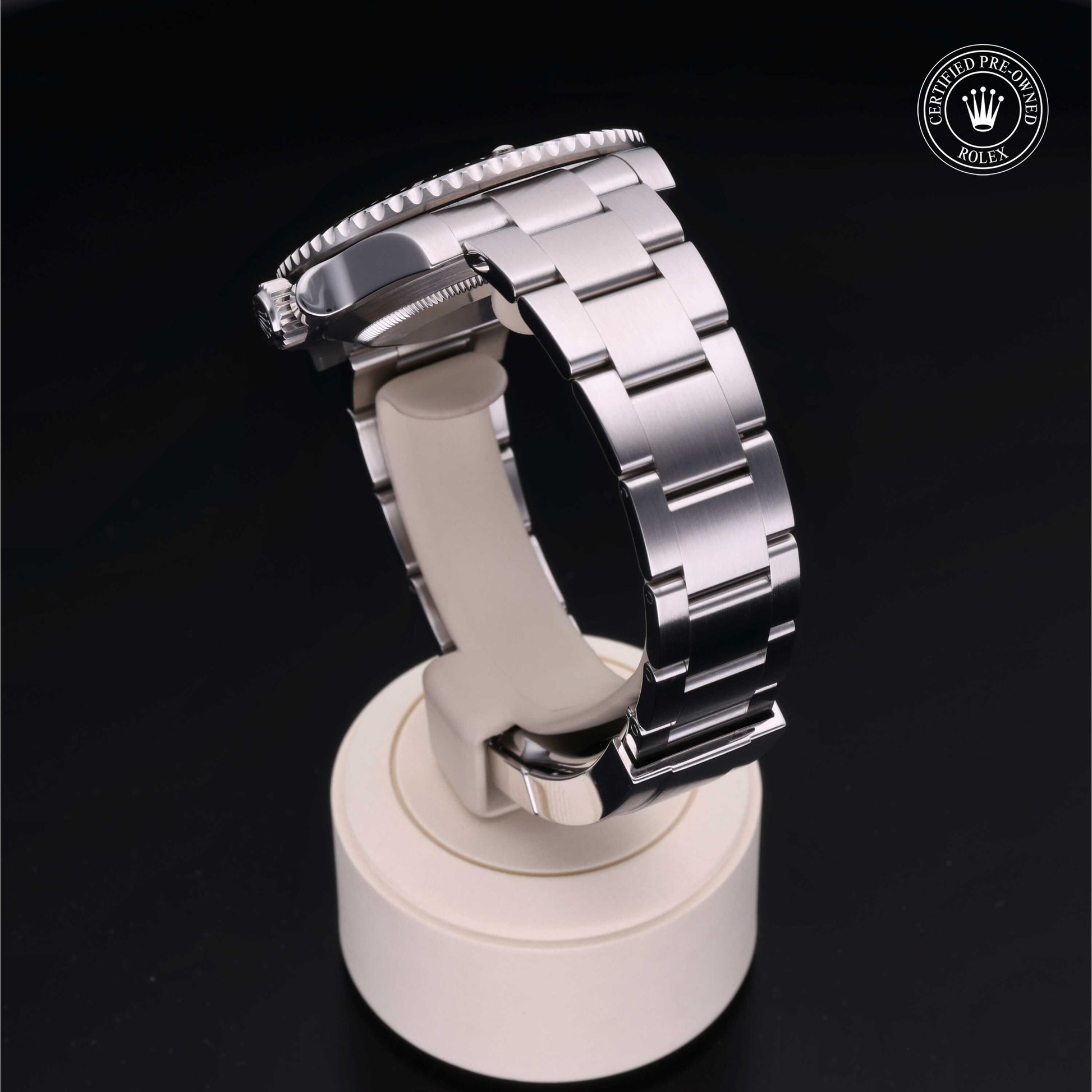 Rolex Submariner watch with steel Oyster bracelet and black dial on a white background.