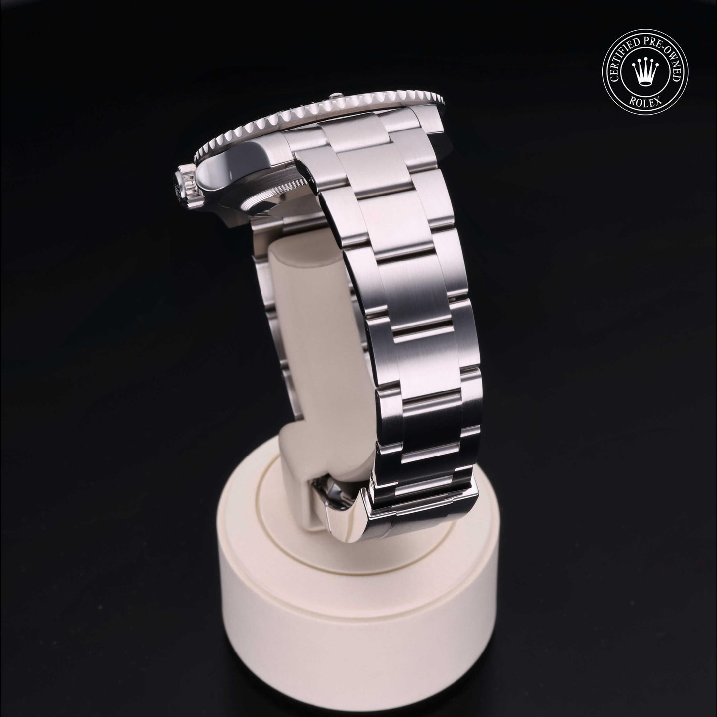 Rolex Submariner watch with steel Oyster bracelet and black dial on a white background.