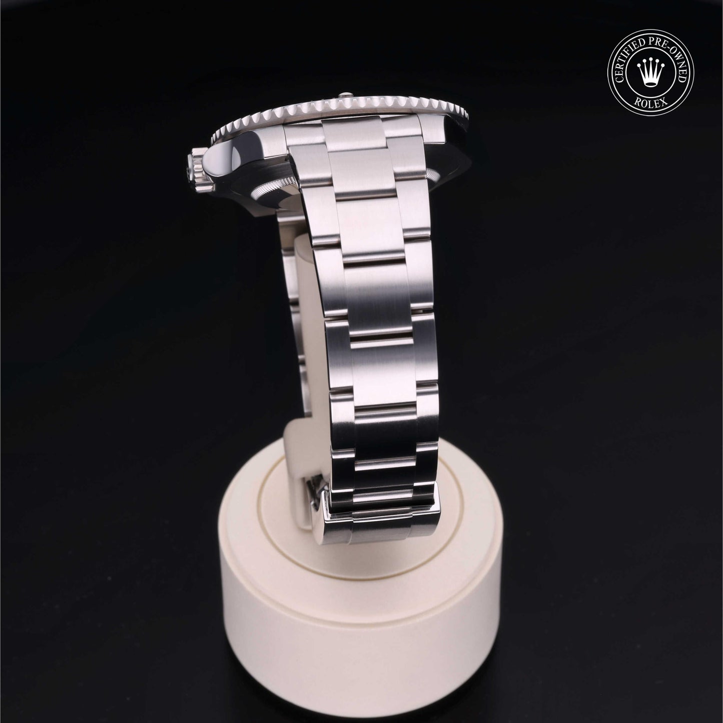 Rolex Submariner watch with steel Oyster bracelet and black dial on a white background.