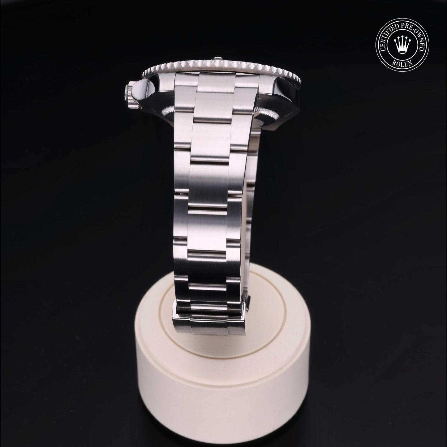 Rolex Submariner watch with steel Oyster bracelet and black dial on a white background.