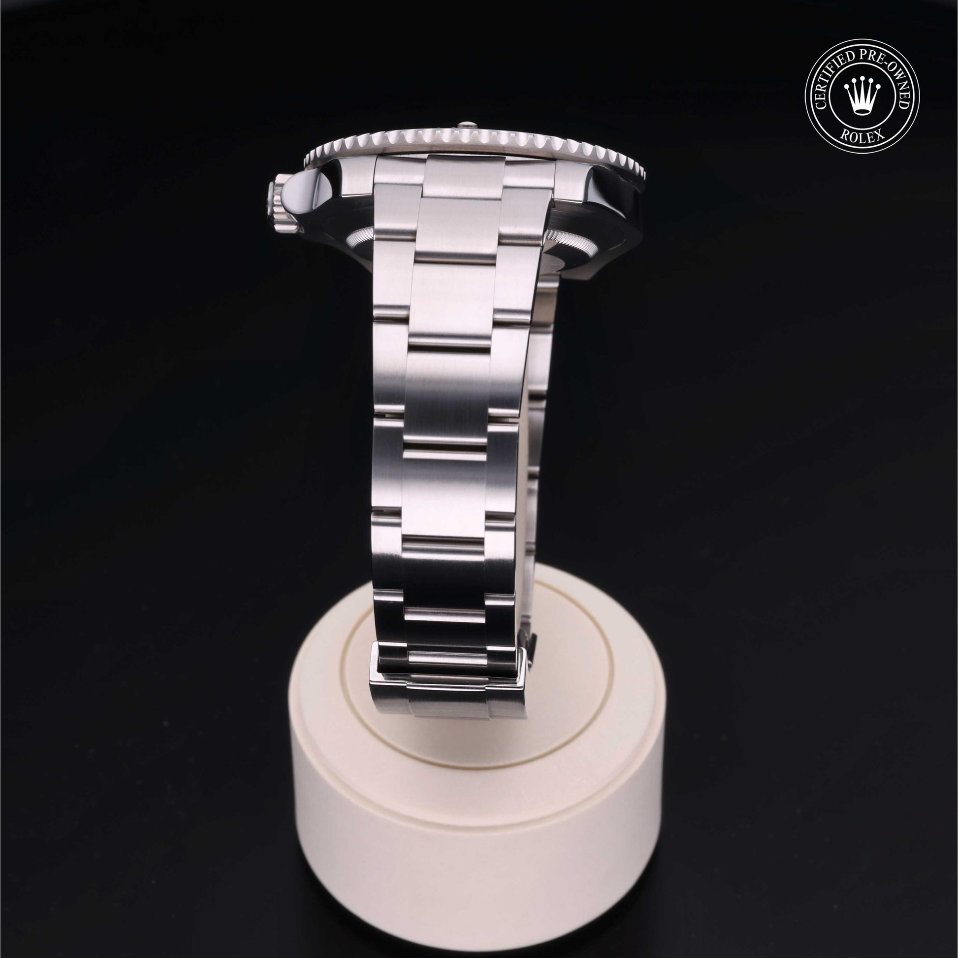 Rolex Submariner watch with steel Oyster bracelet and black dial on a white background.