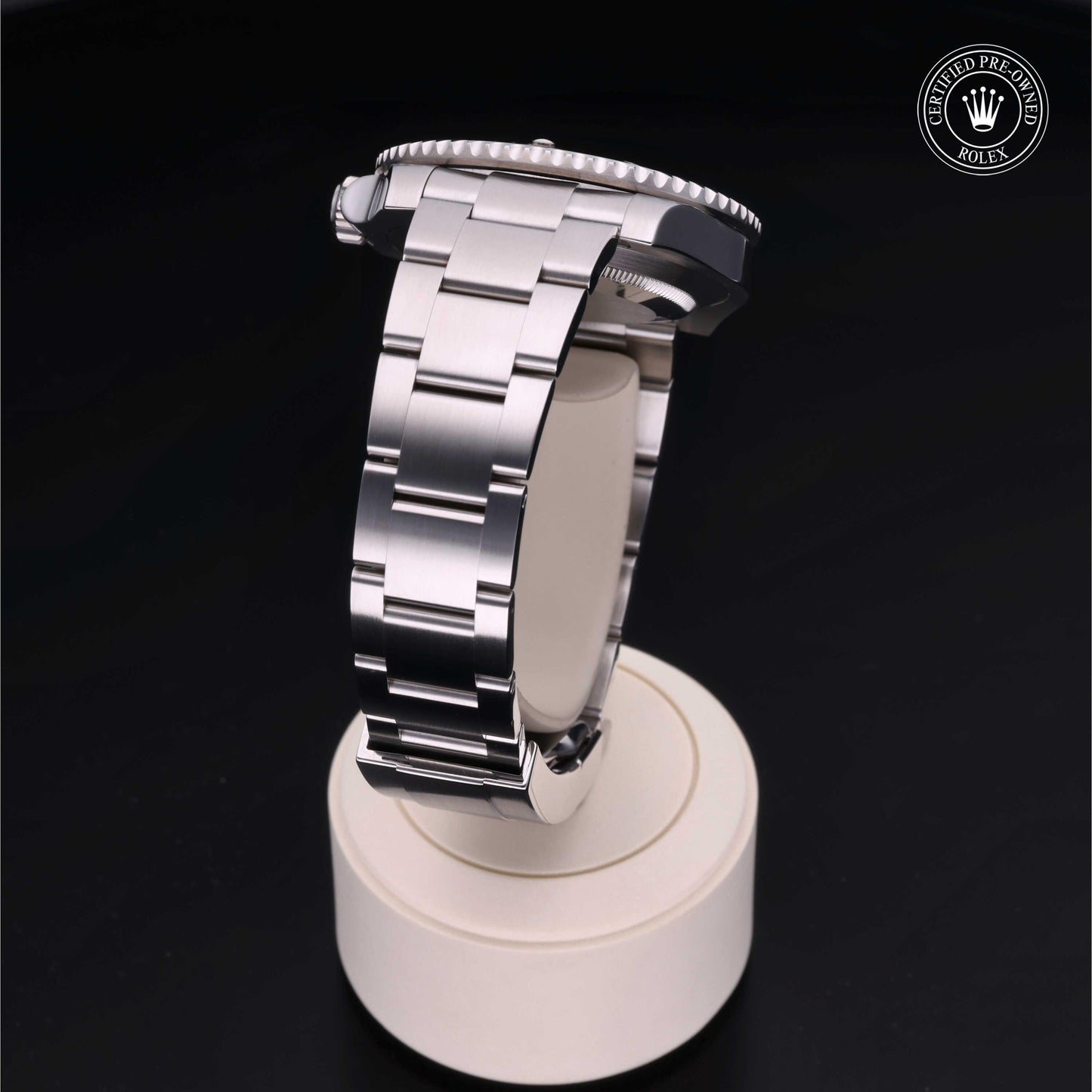 Rolex Submariner watch with steel Oyster bracelet and black dial on a white background.