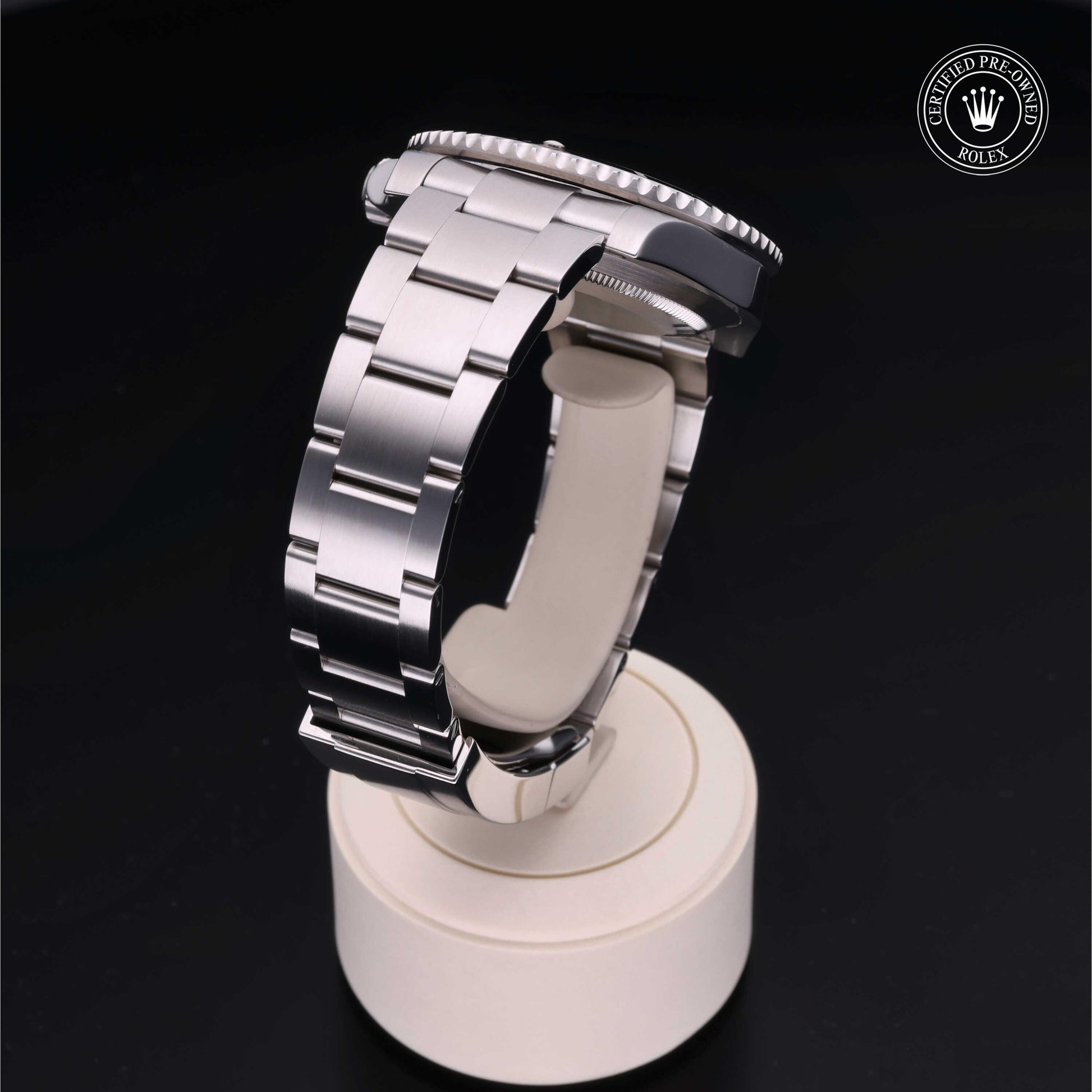 Rolex Submariner watch with steel Oyster bracelet and black dial on a white background.