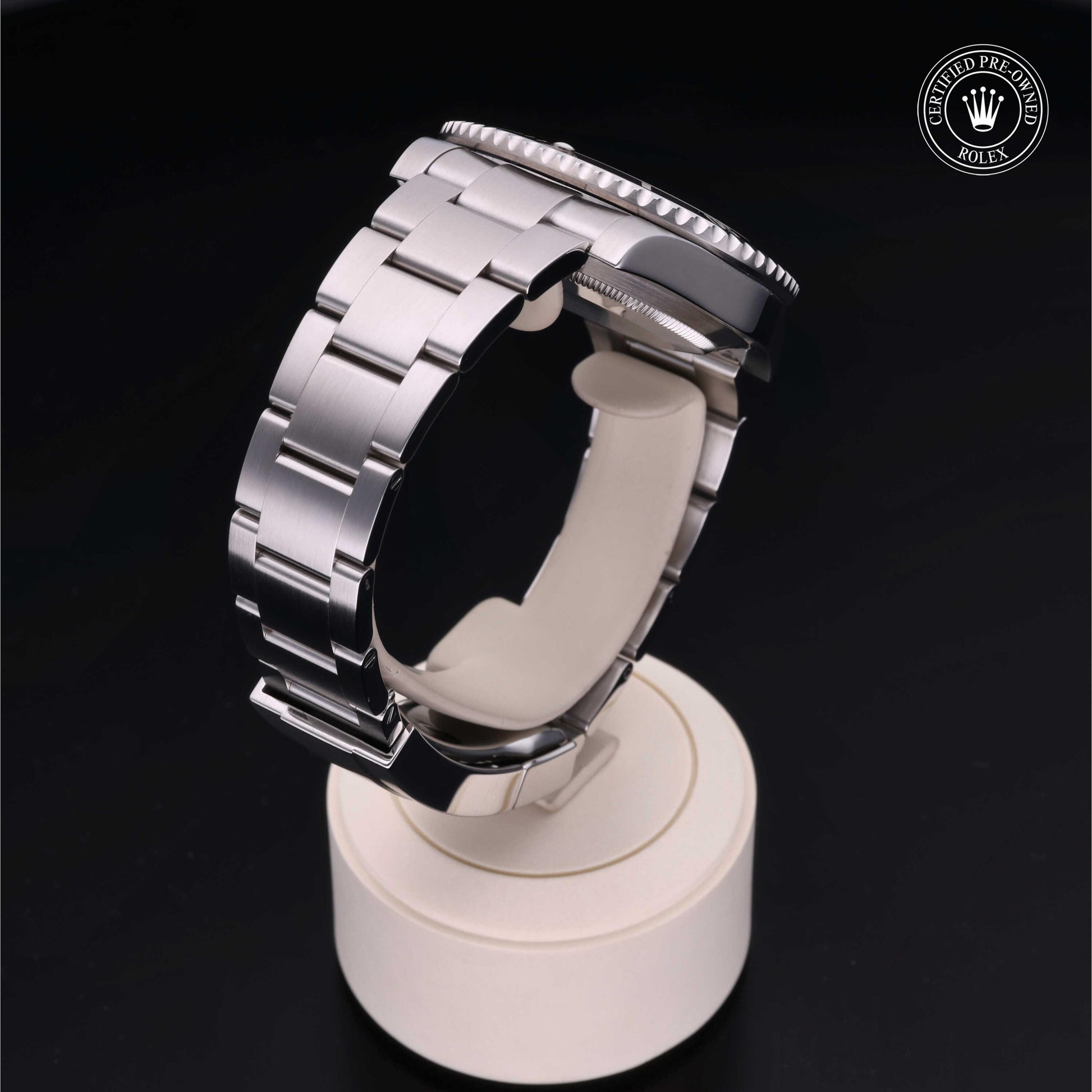 Rolex Submariner watch with steel Oyster bracelet and black dial on a white background.