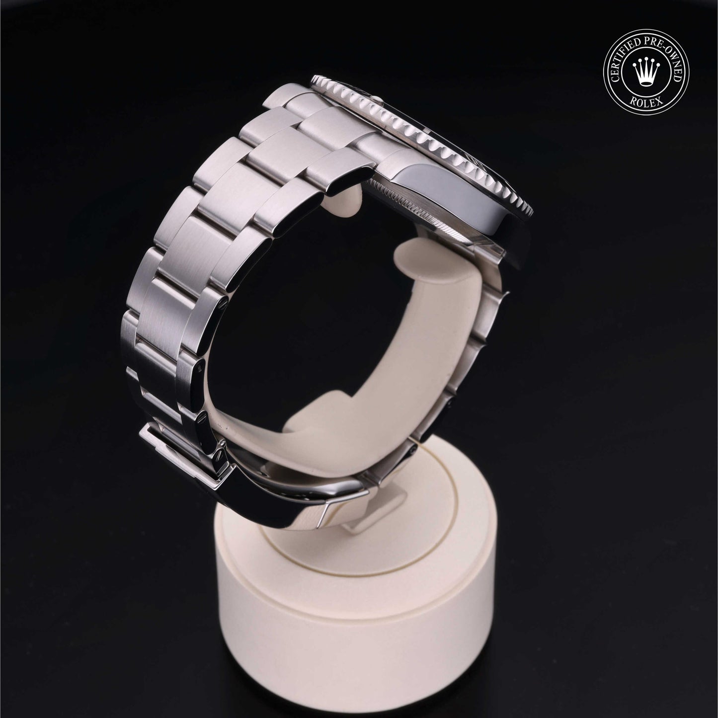 Rolex Submariner watch with steel Oyster bracelet and black dial on a white background.