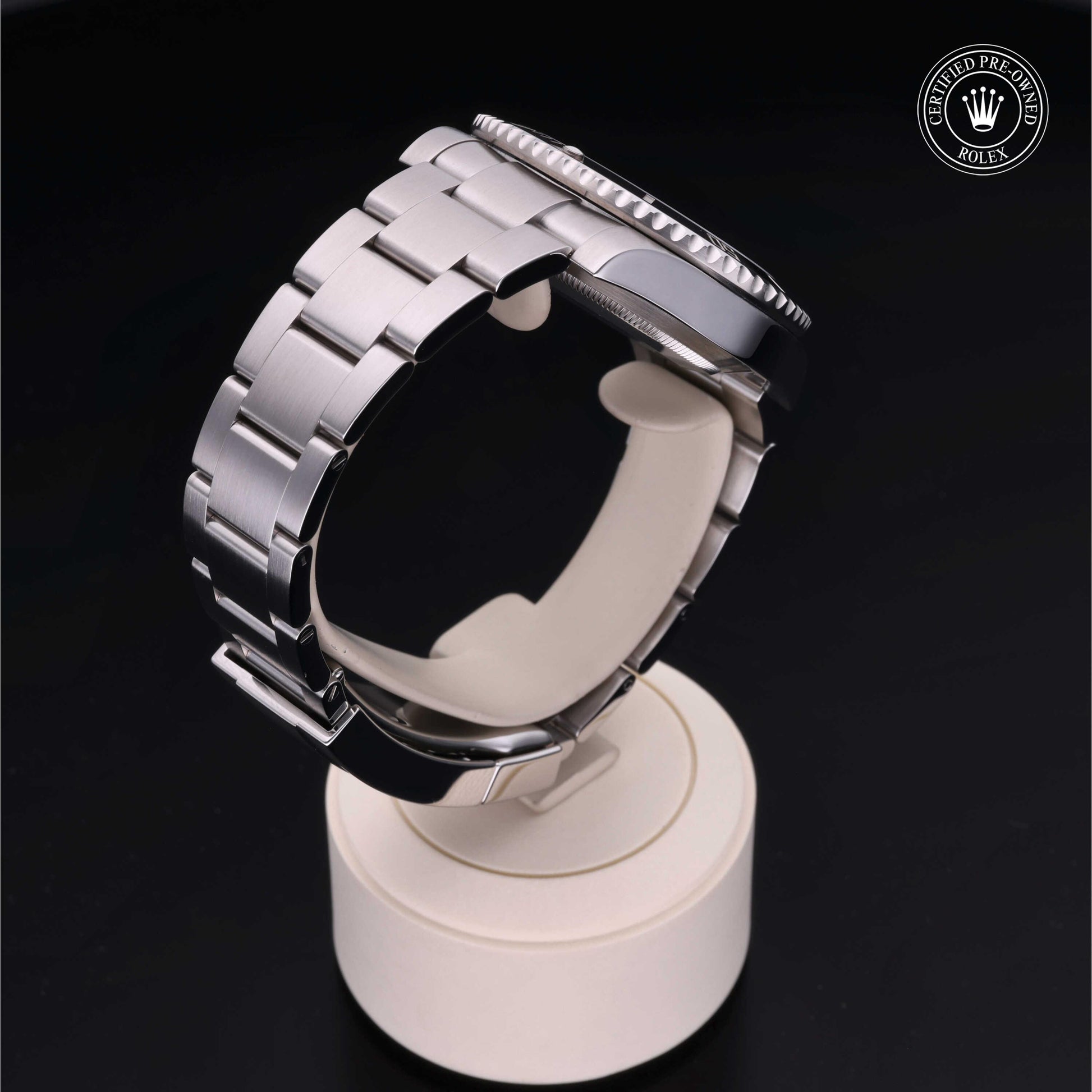 Rolex Submariner watch with steel Oyster bracelet and black dial on a white background.