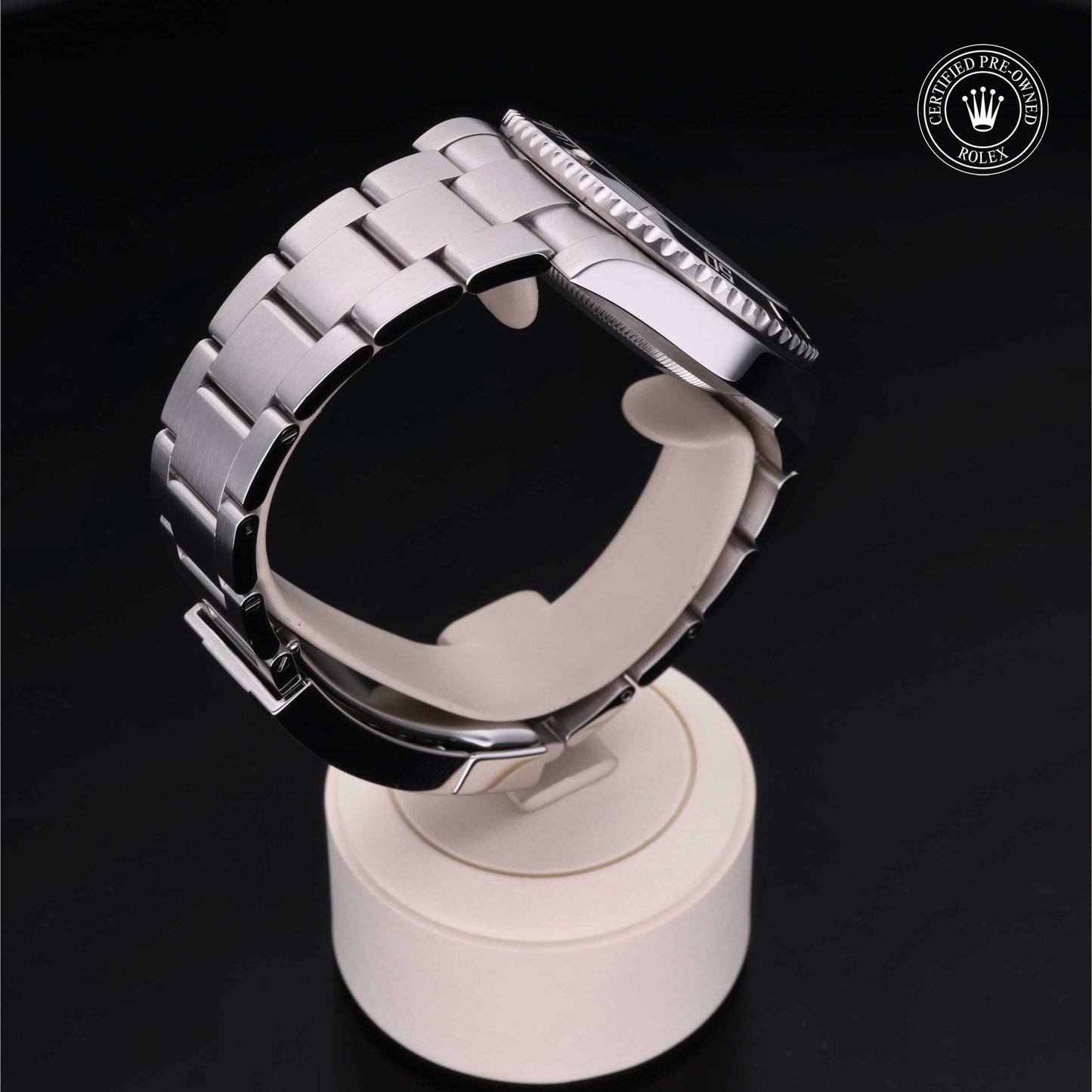 Rolex Submariner watch with steel Oyster bracelet and black dial on a white background.