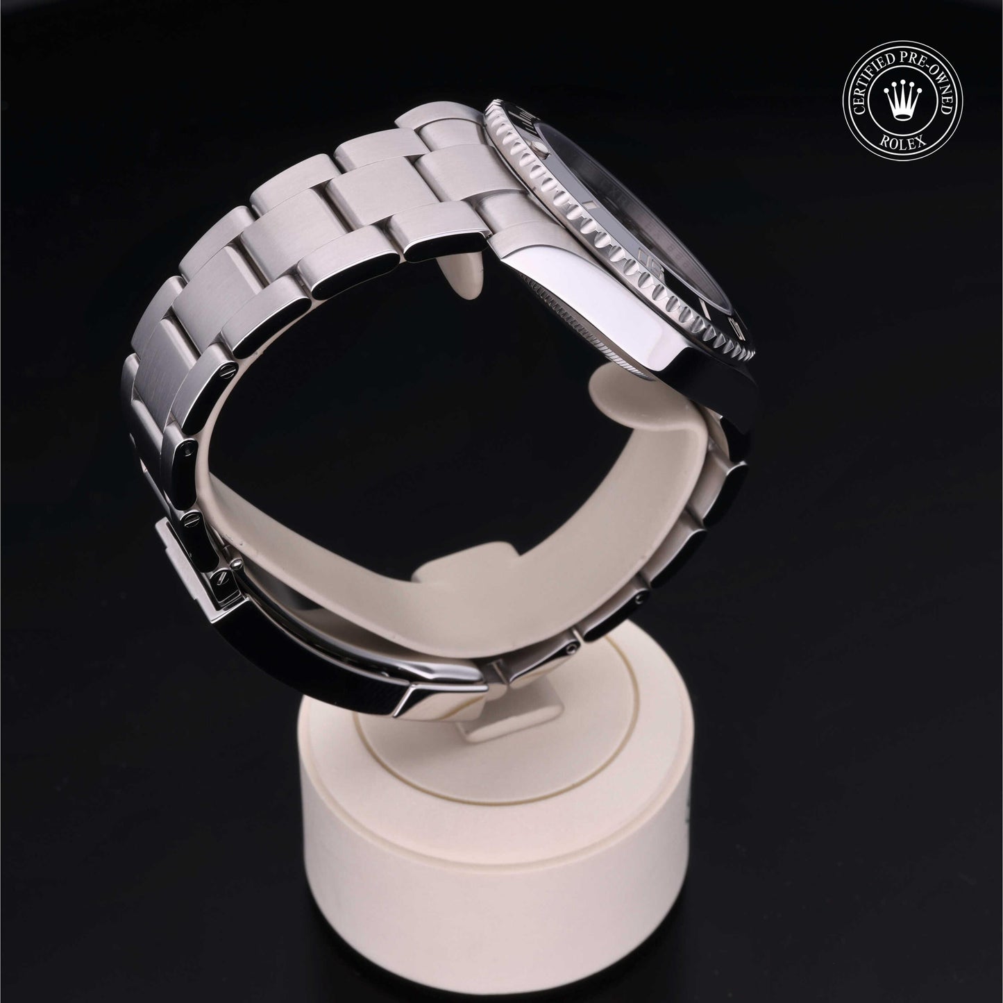 Rolex Submariner watch with steel Oyster bracelet and black dial on a white background.