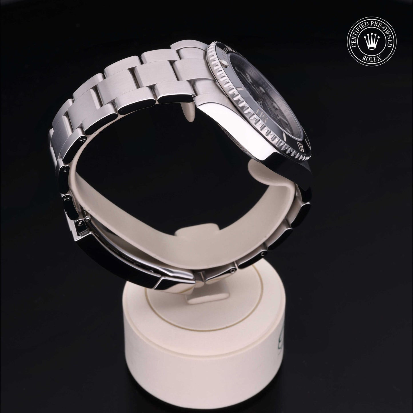 Rolex Submariner watch with steel Oyster bracelet and black dial on a white background.