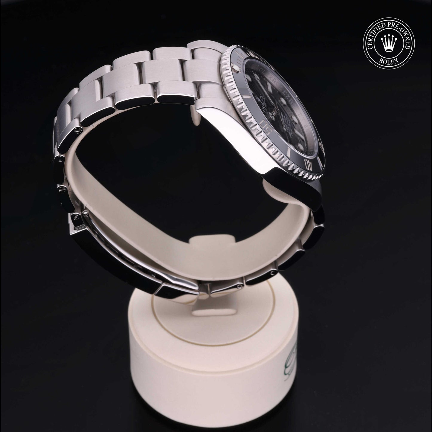 Rolex Submariner watch with steel Oyster bracelet and black dial on a white background.