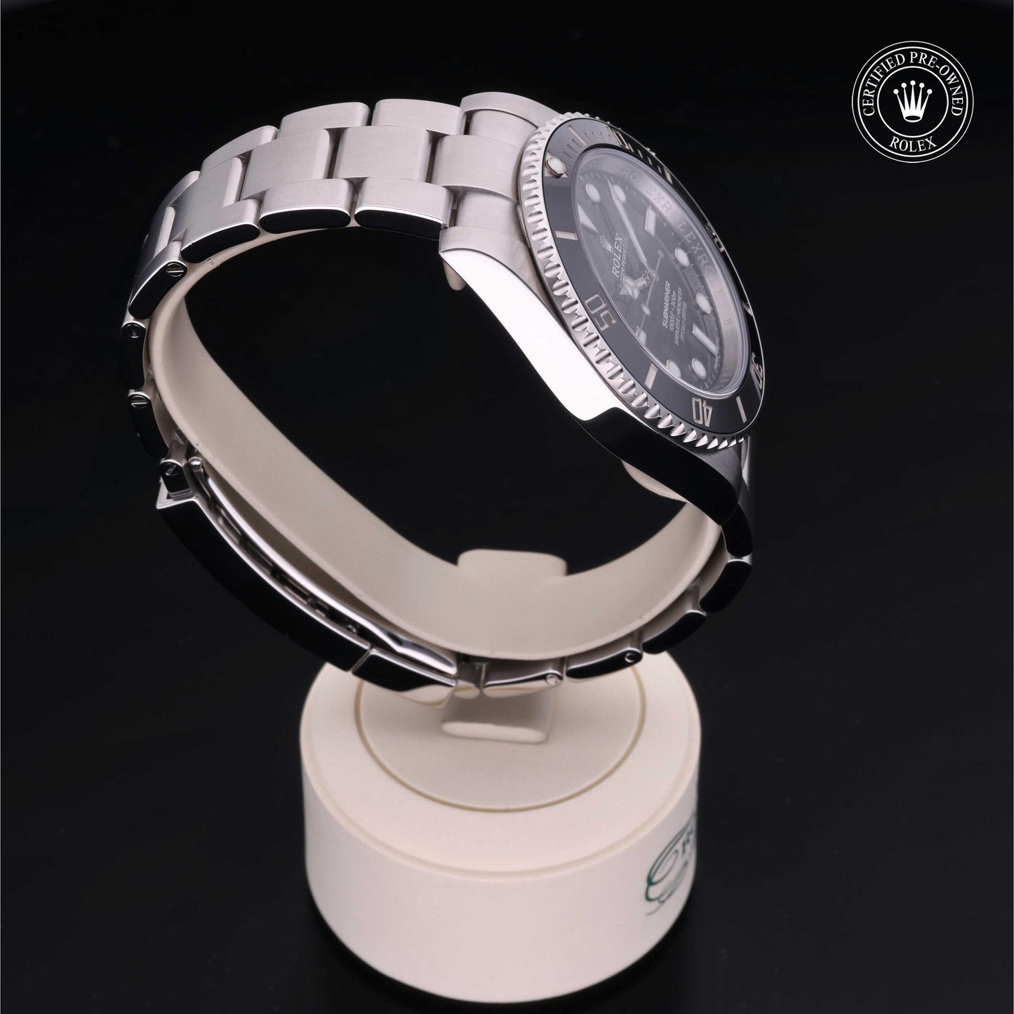 Rolex Submariner watch with steel Oyster bracelet and black dial on a white background.