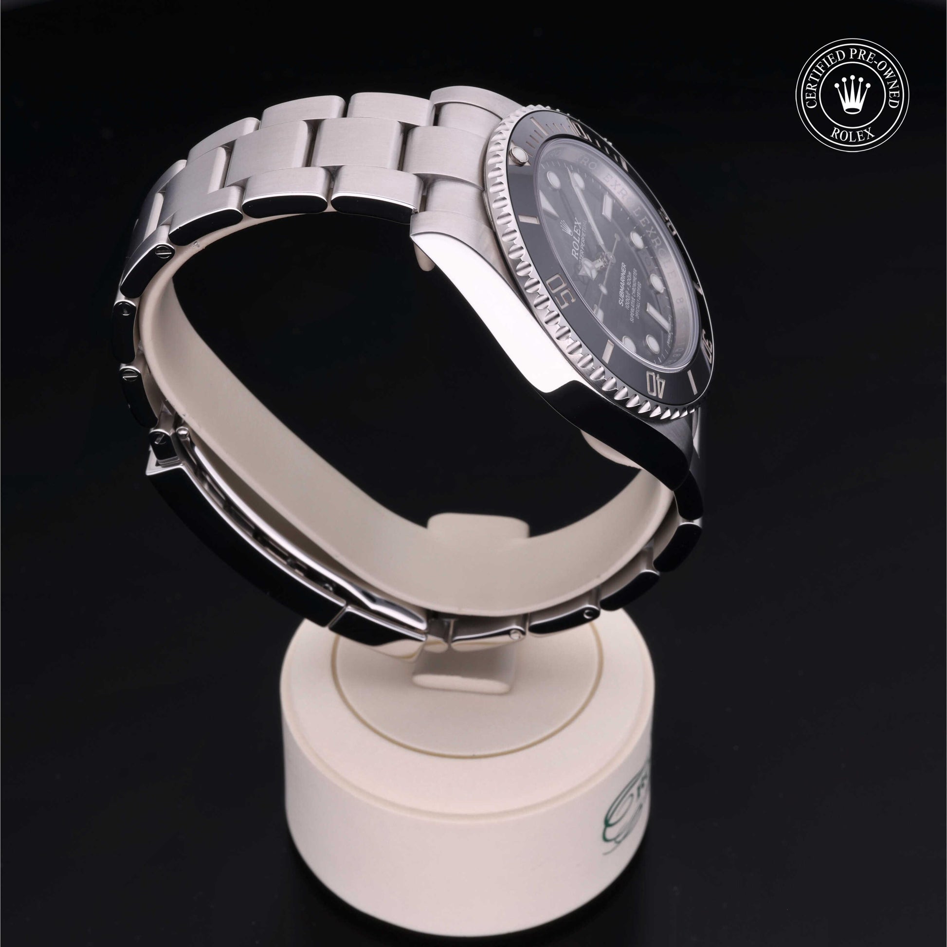 Rolex Submariner watch with steel Oyster bracelet and black dial on a white background.