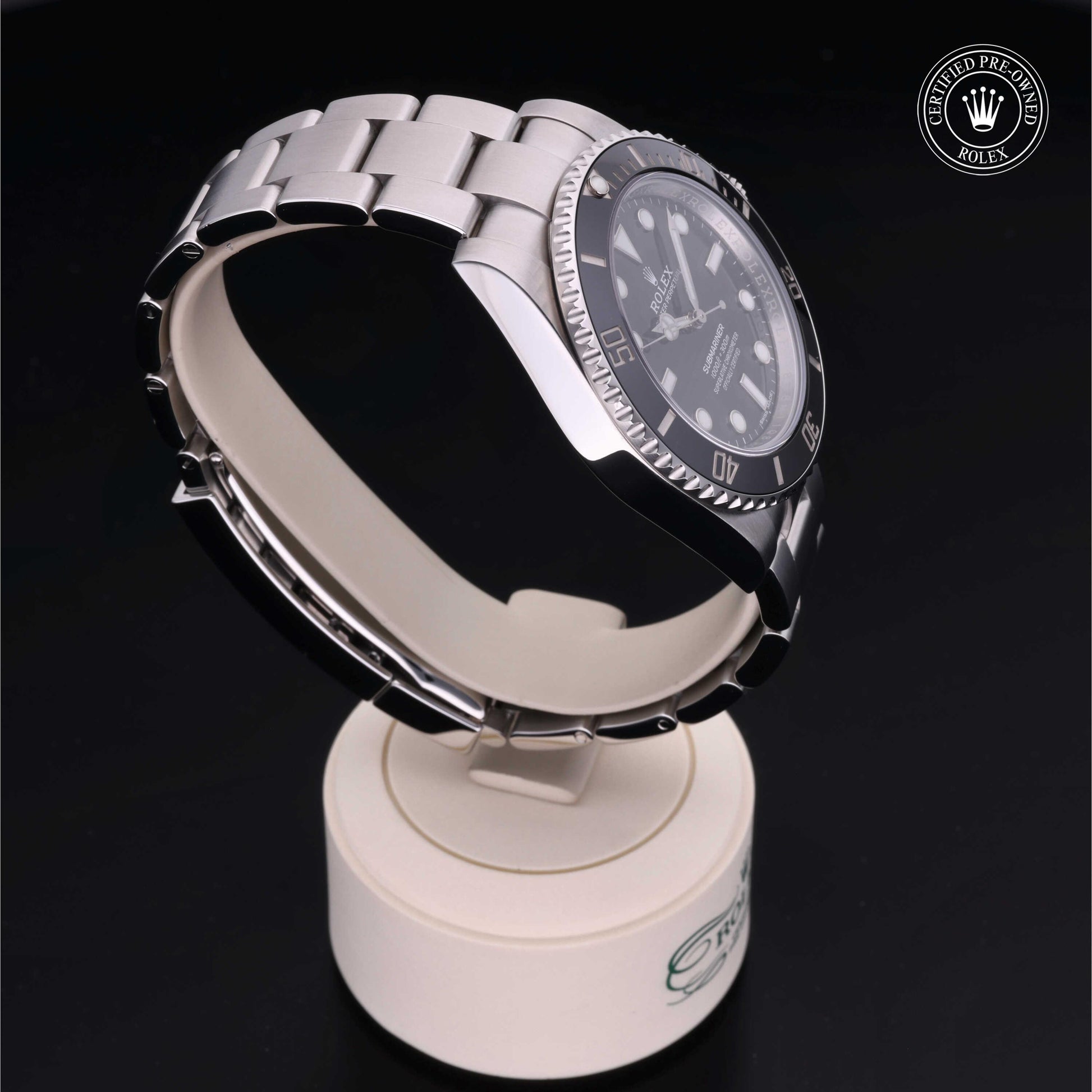 Rolex Submariner watch with steel Oyster bracelet and black dial on a white background.