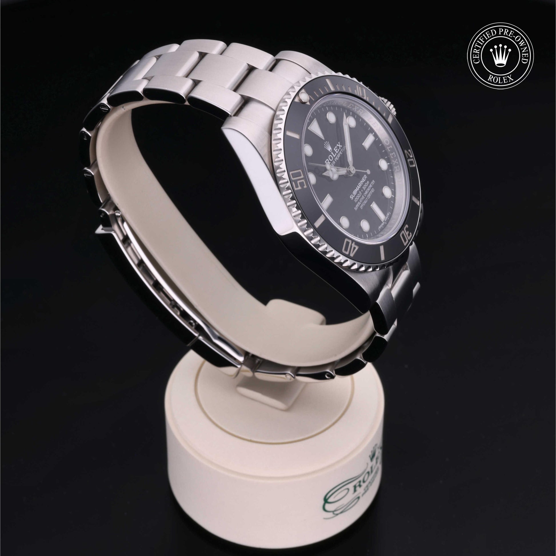 Rolex Submariner watch with steel Oyster bracelet and black dial on a white background.