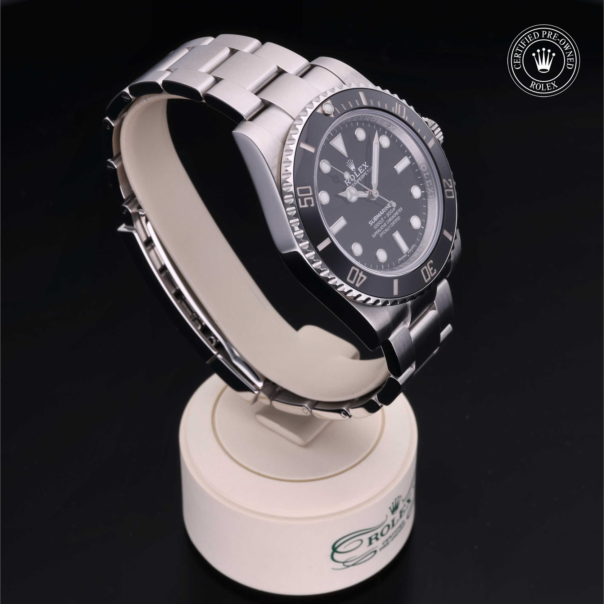 Rolex Submariner watch with steel Oyster bracelet and black dial on a white background.