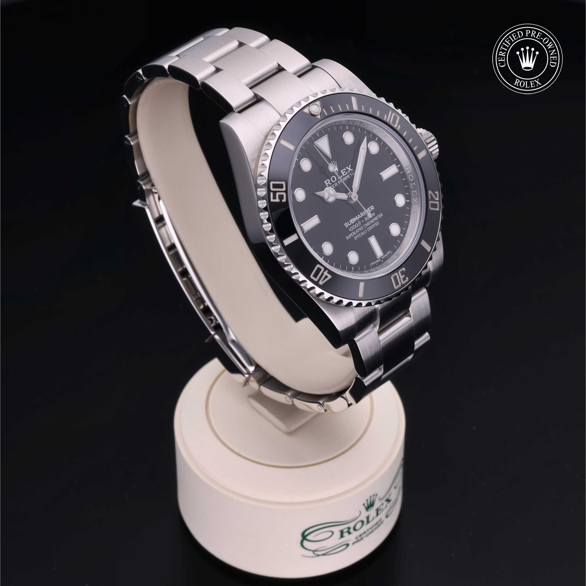 Rolex Submariner watch with steel Oyster bracelet and black dial on a white background.