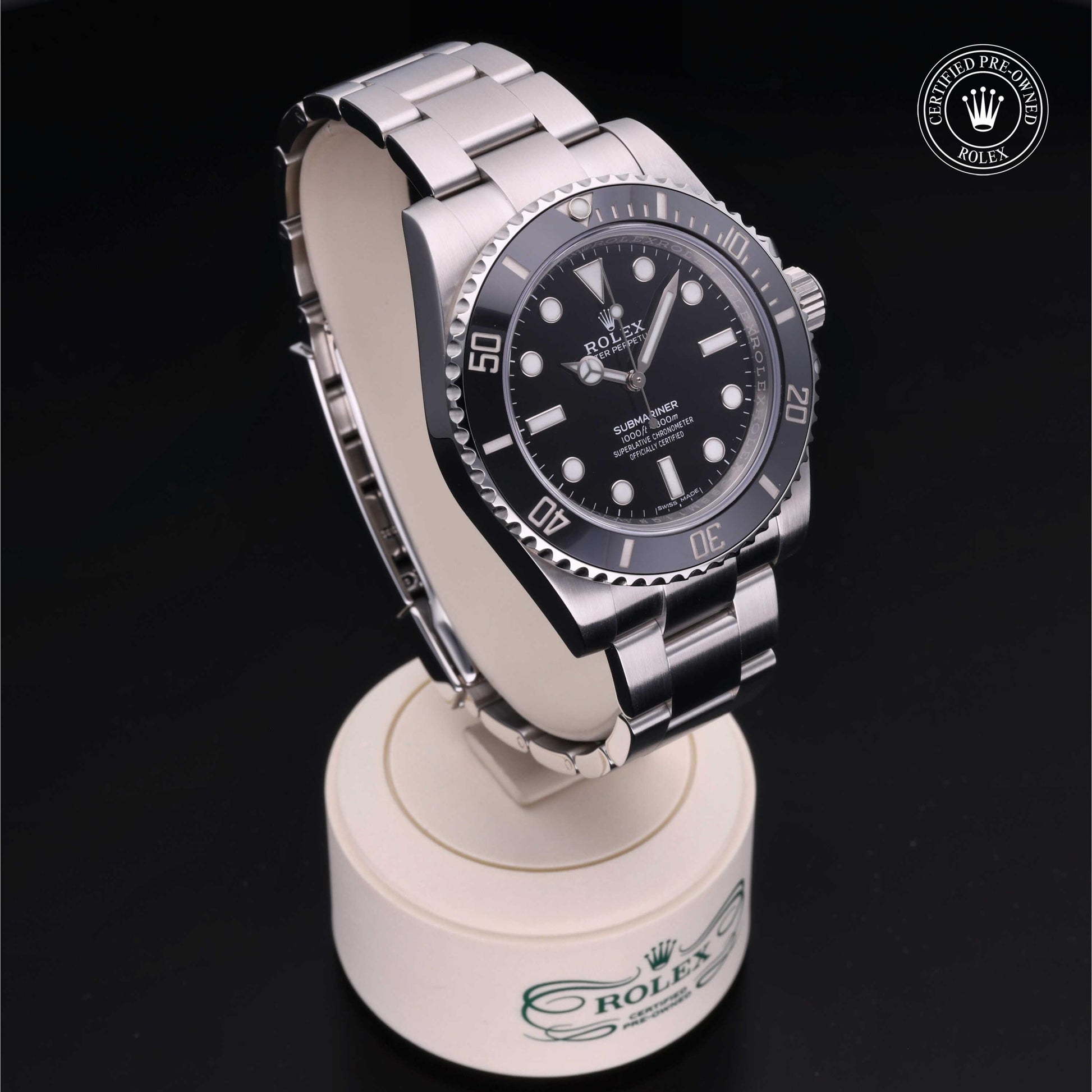 Rolex Submariner watch with steel Oyster bracelet and black dial on a white background.