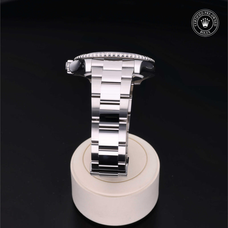 Rolex Yacht-Master watch with a steel Oyster bracelet and slate dial, presented on a cream stand with black background.Yacht-Master 40