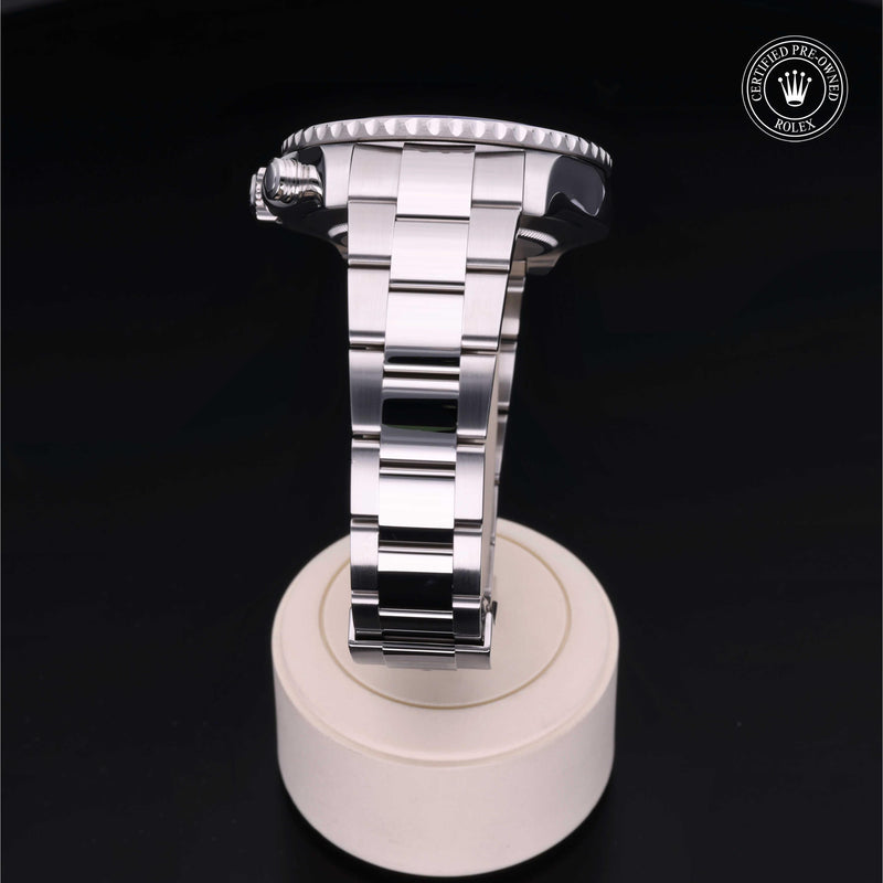 Rolex Yacht-Master II watch with a steel Oyster bracelet and white dial on a cream stand with a black background.Yacht-Master II