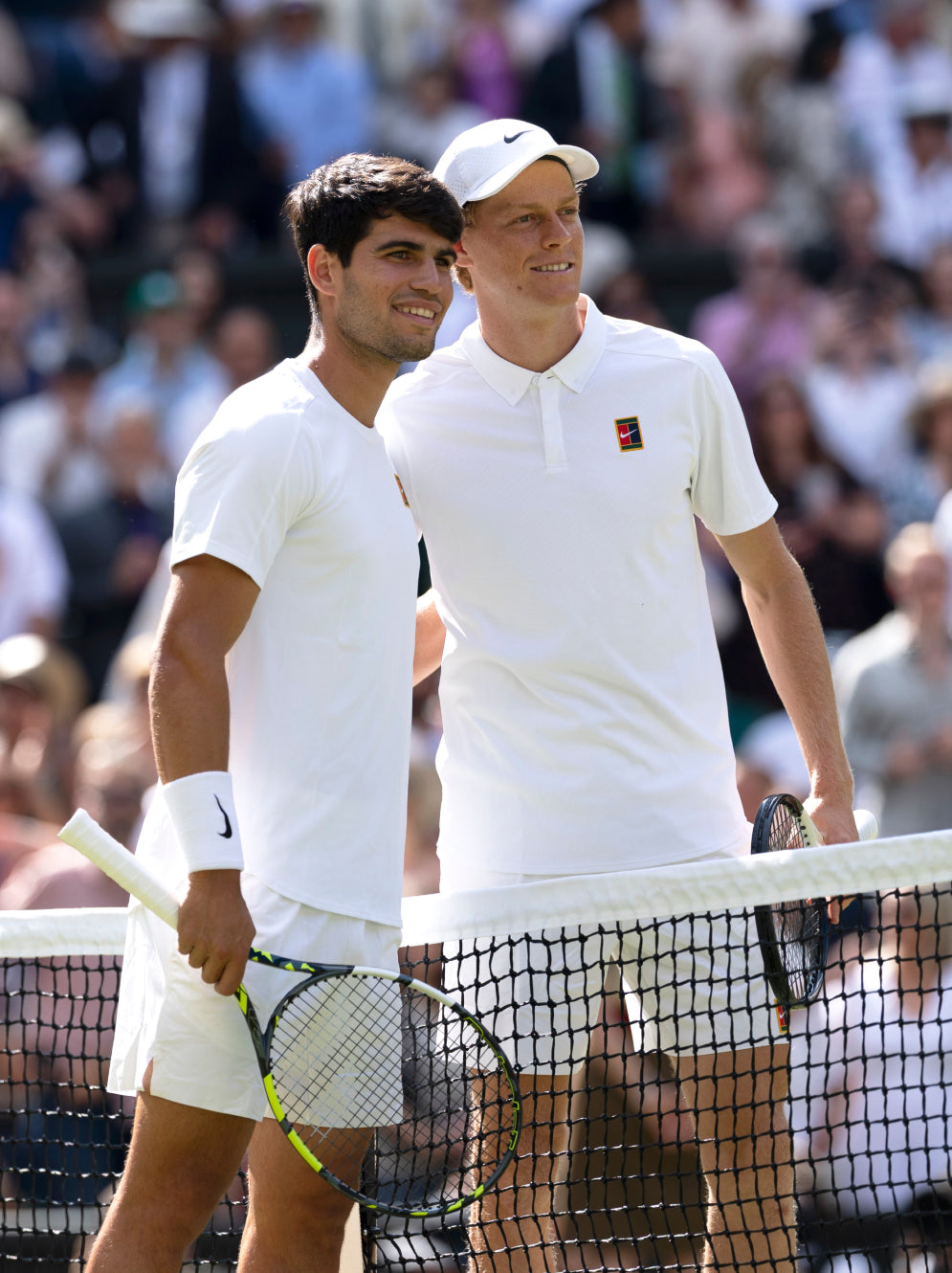 Two tennis players on a tennis court with a crowd in the background