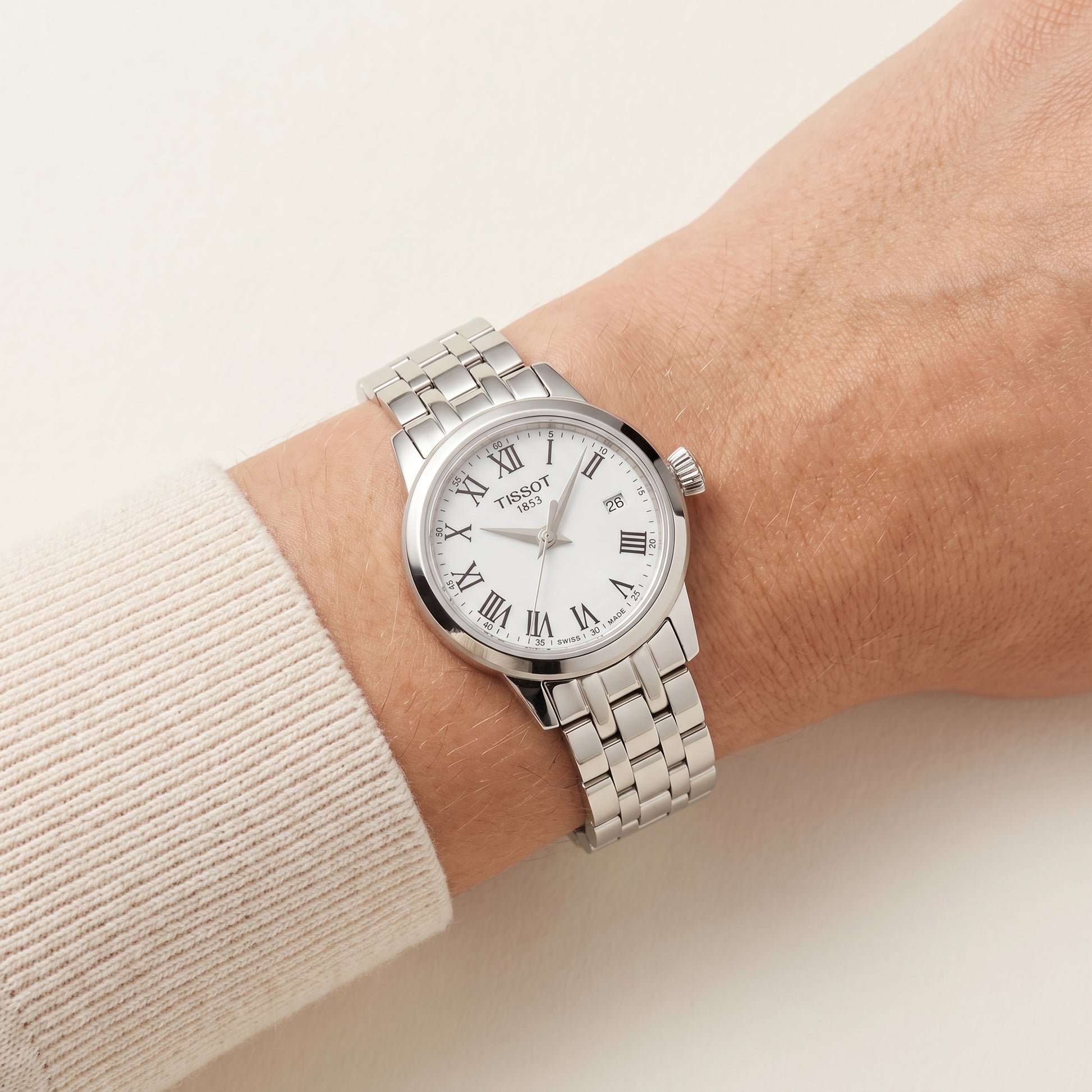 Tissot Classic Dream with steel bracelet and white dial on a ladies wrist.
