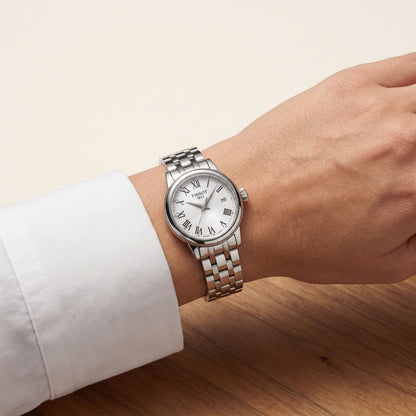 Tissot Classic Dream with steel bracelet and white dial on a ladies wrist.