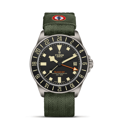 TUDOR Pelagos FXD GMT with 42mm titanium case, green fabric strap and black dial on a white background.