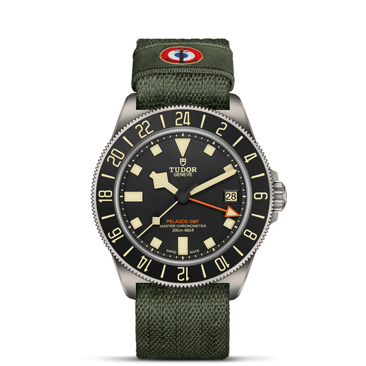 TUDOR Pelagos FXD GMT with 42mm titanium case, green fabric strap and black dial on a white background.