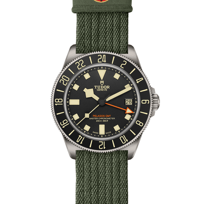 TUDOR Pelagos FXD GMT with 42mm titanium case, green fabric strap and black dial on a white background.