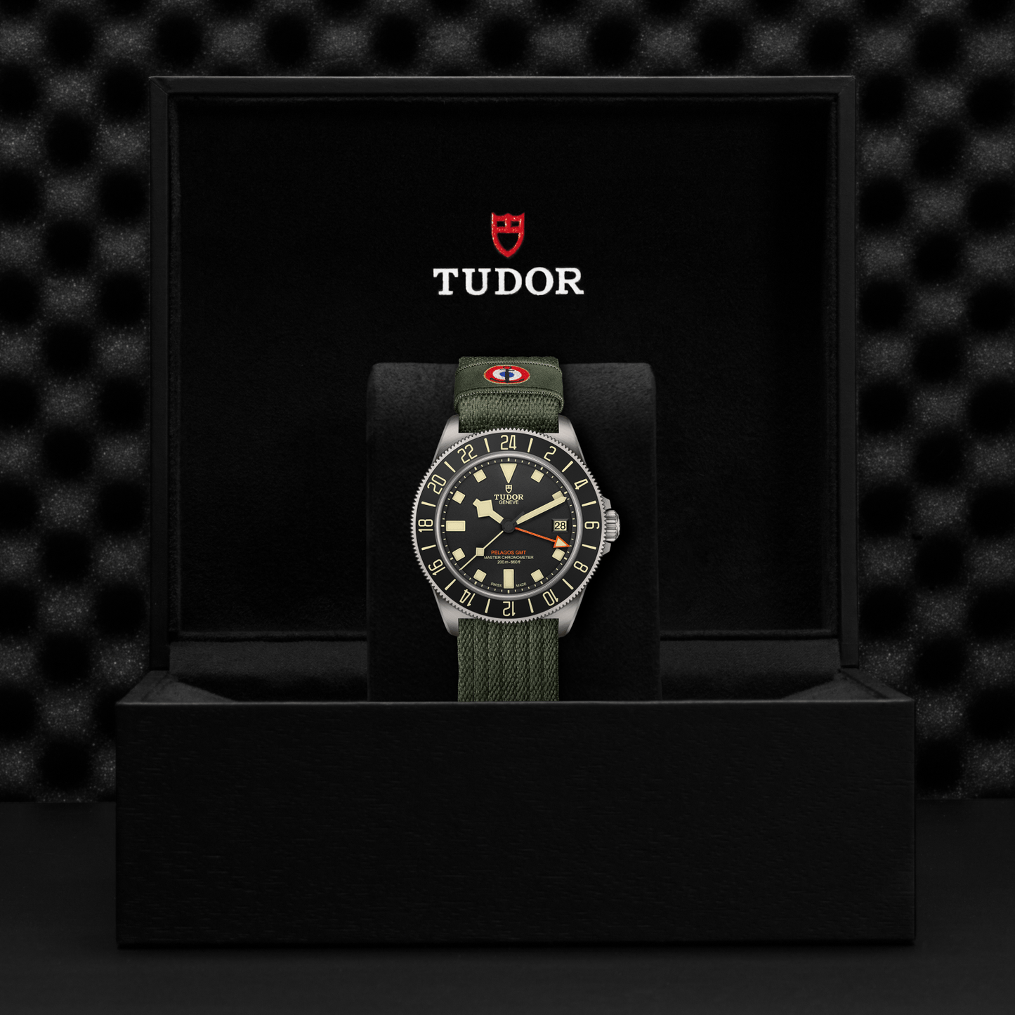 TUDOR Pelagos FXD GMT with 42mm titanium case, green fabric strap and black dial in black presentation box.