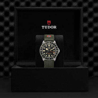 TUDOR Pelagos FXD GMT with 42mm titanium case, green fabric strap and black dial in black presentation box.
