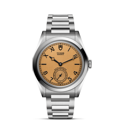 Tudor Monarch watch with steel bracelet and champagne dial on a white background.