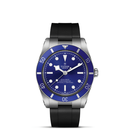 Tudor Black Bay 54 watch with a black rubber strap and blue dial on a white background.